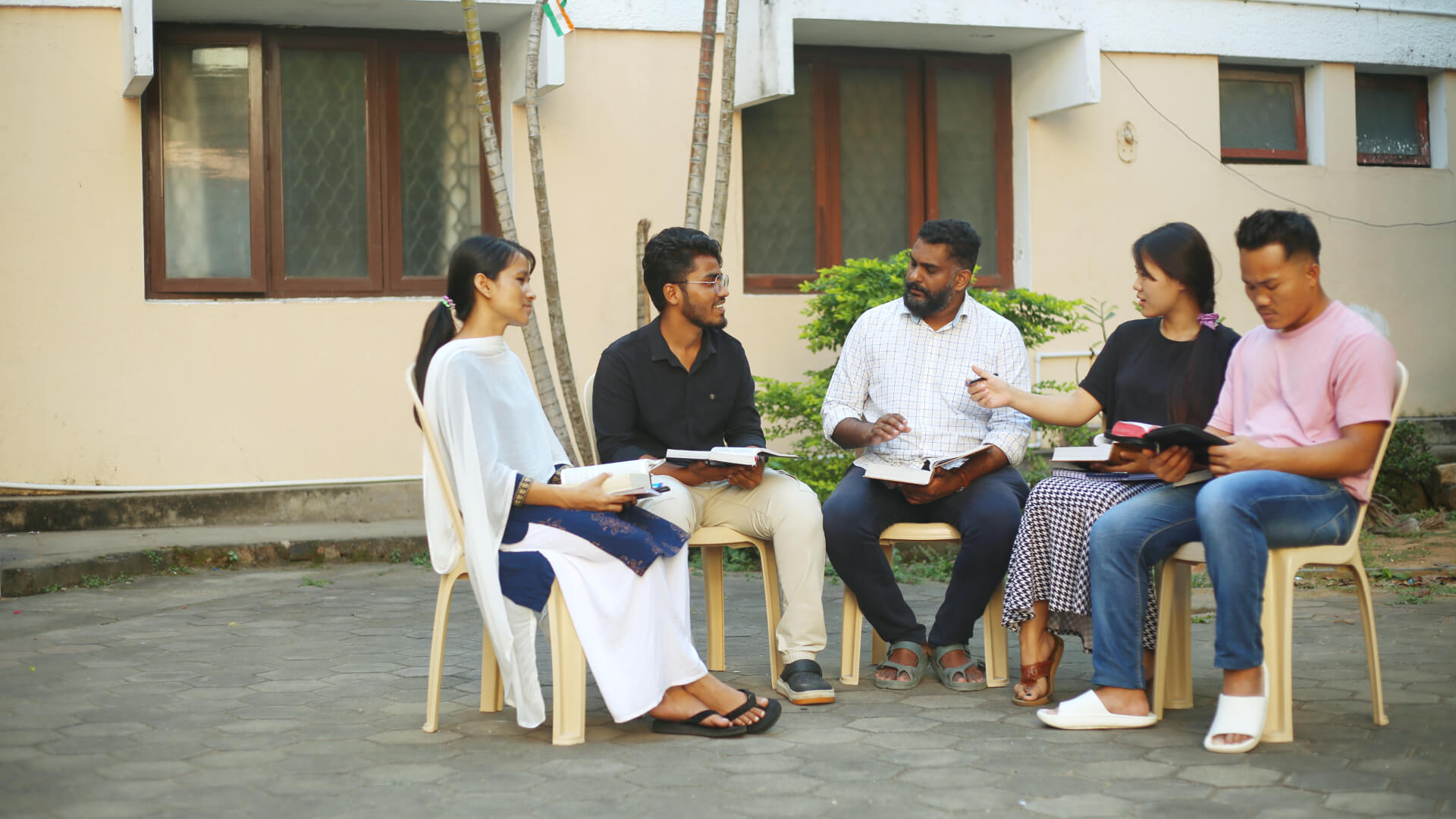 Students Dicsussing with Staff Outdoor