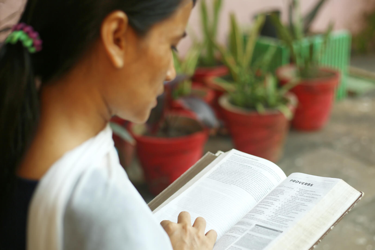 Student Reading Bible in College